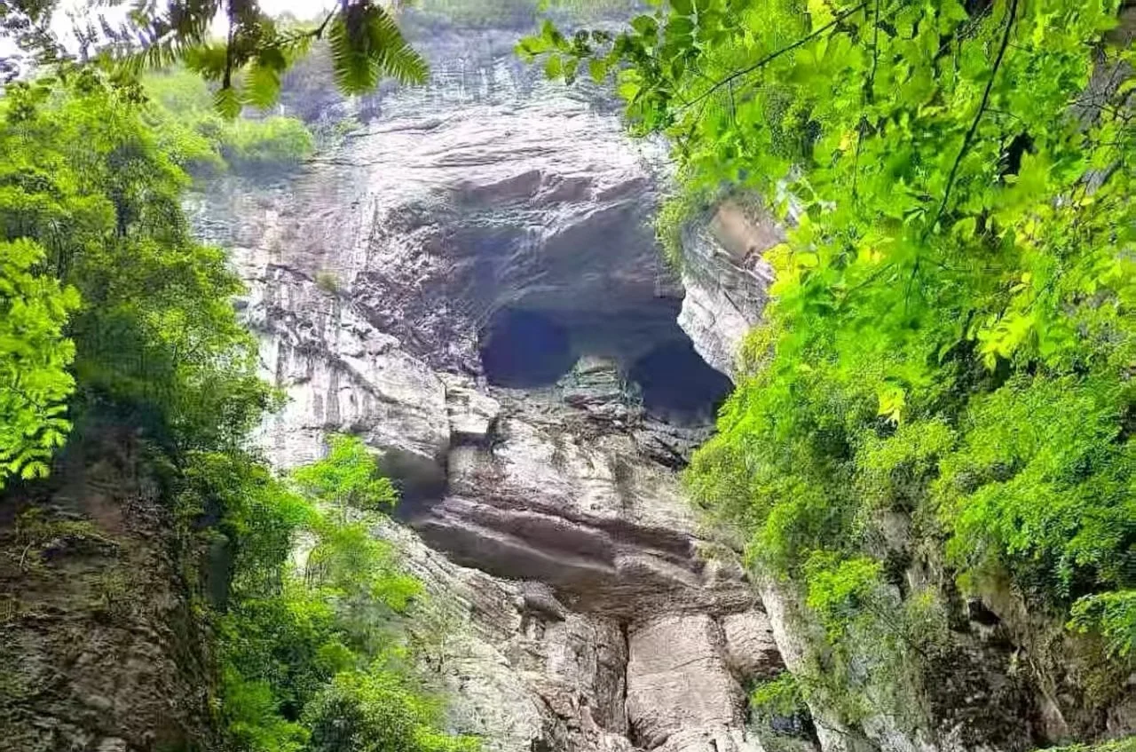 Three Natural Bridges stone arch spanning a deep karst ravine in Wulong