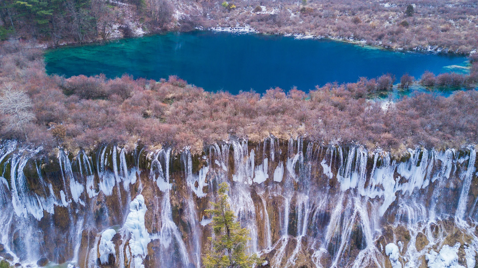 Turquoise lake and waterfall in Jiuzhaigou Valley National Park, Sichuan