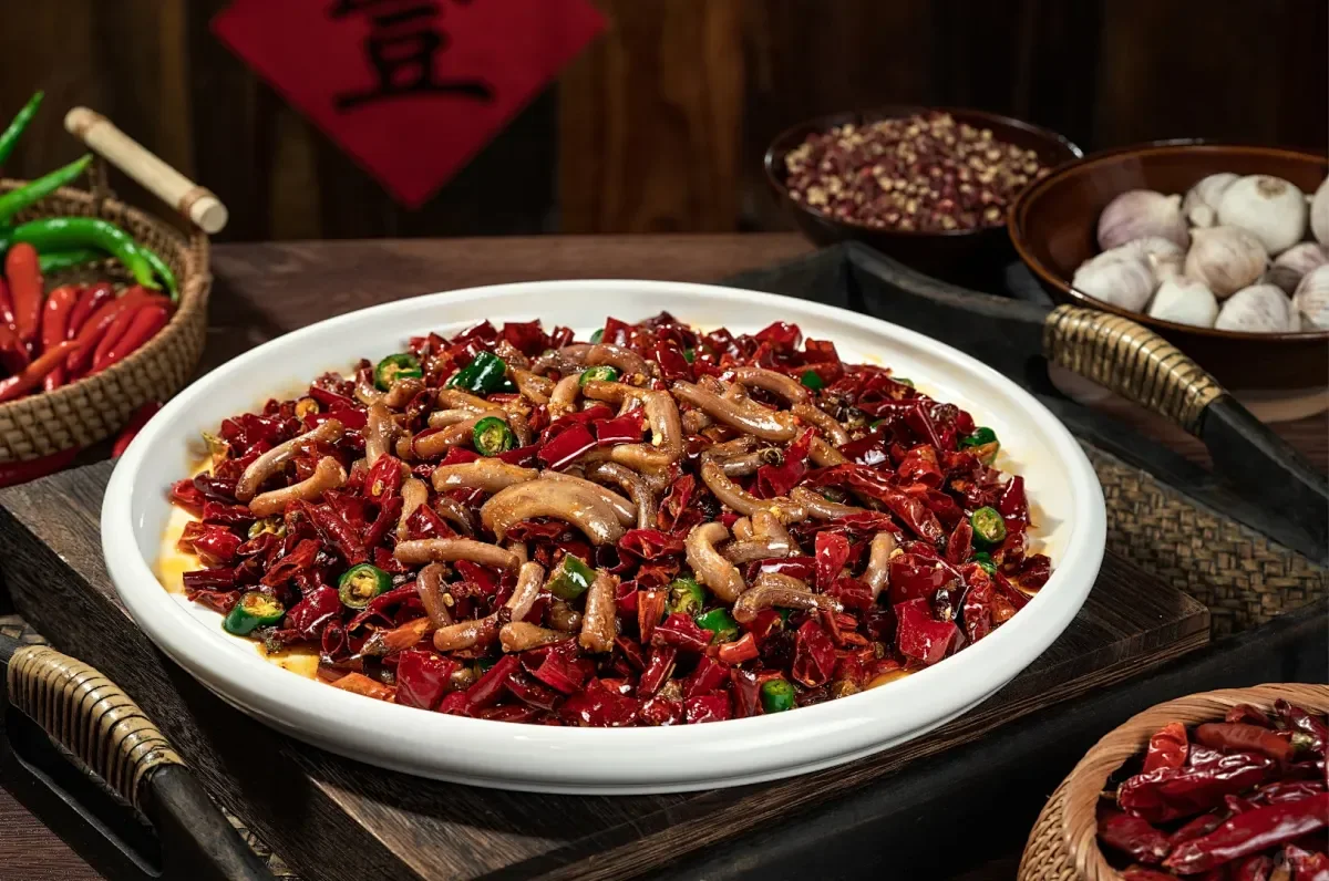 Chongqing noodles topped with chili oil, peanuts, and fresh herbs
