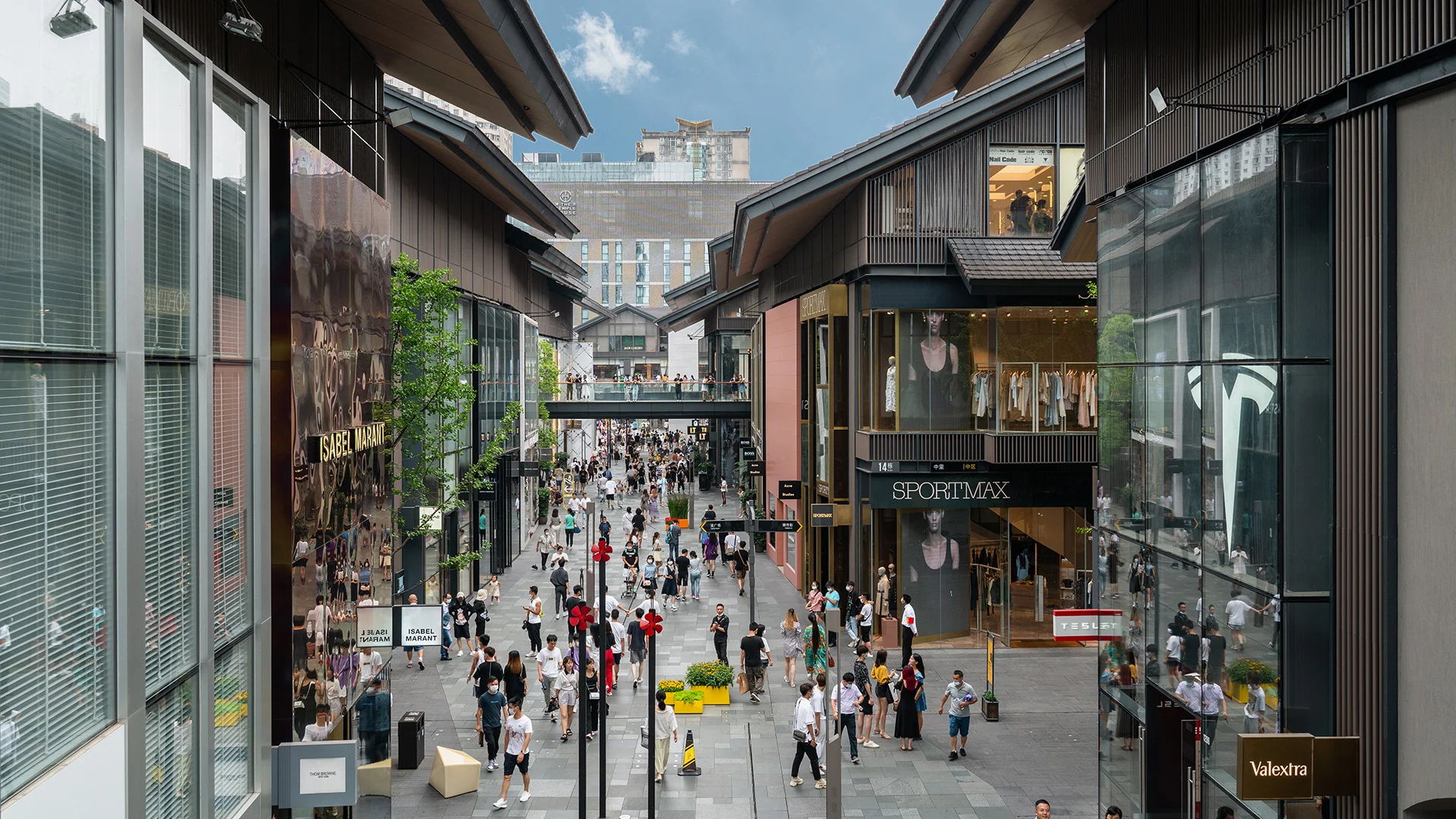 Modern shopping mall interior in Chengdu with bright storefronts and escalators