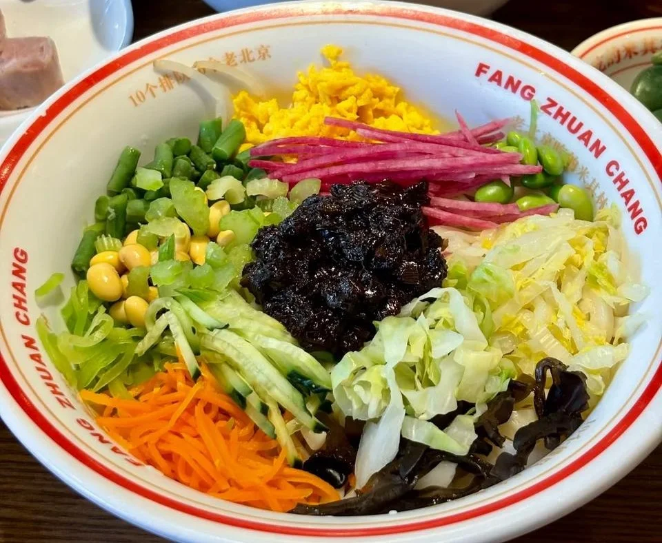 Street vendor preparing jianbing at a Beijing food market