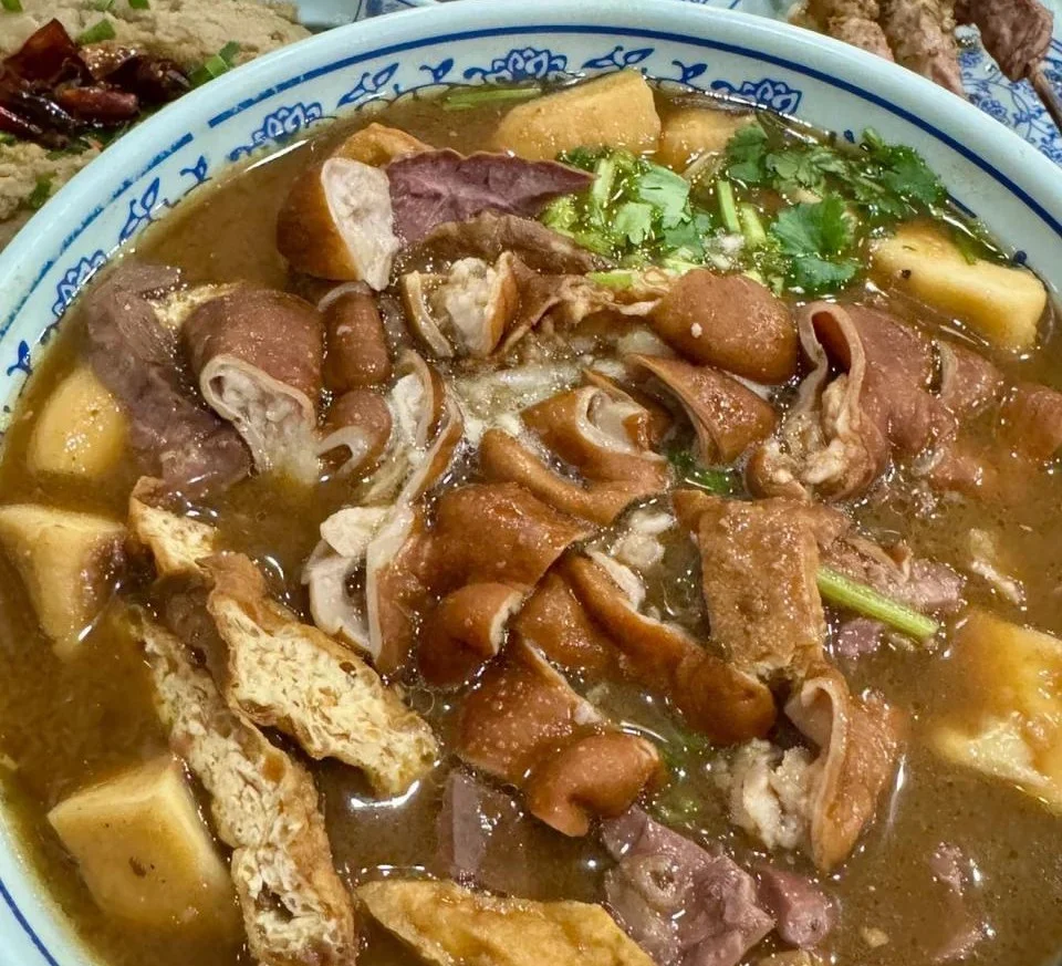 Travelers in Beijing airport or railway station with luggage and signs