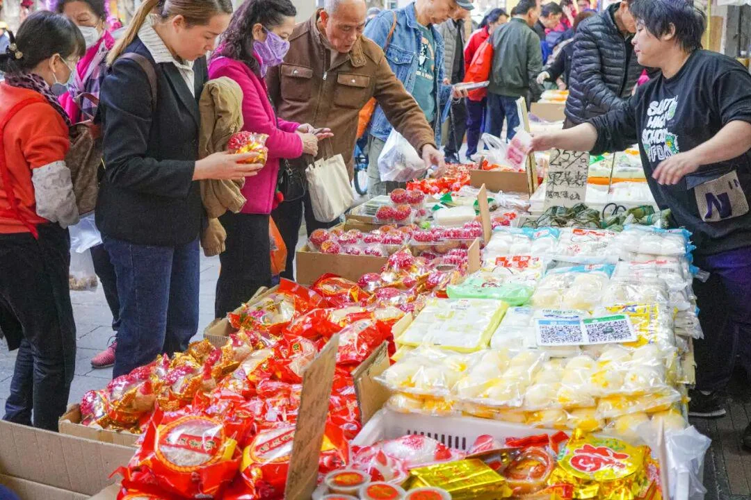 Crowded Guangzhou market district with wholesale storefronts and bulk merchandise