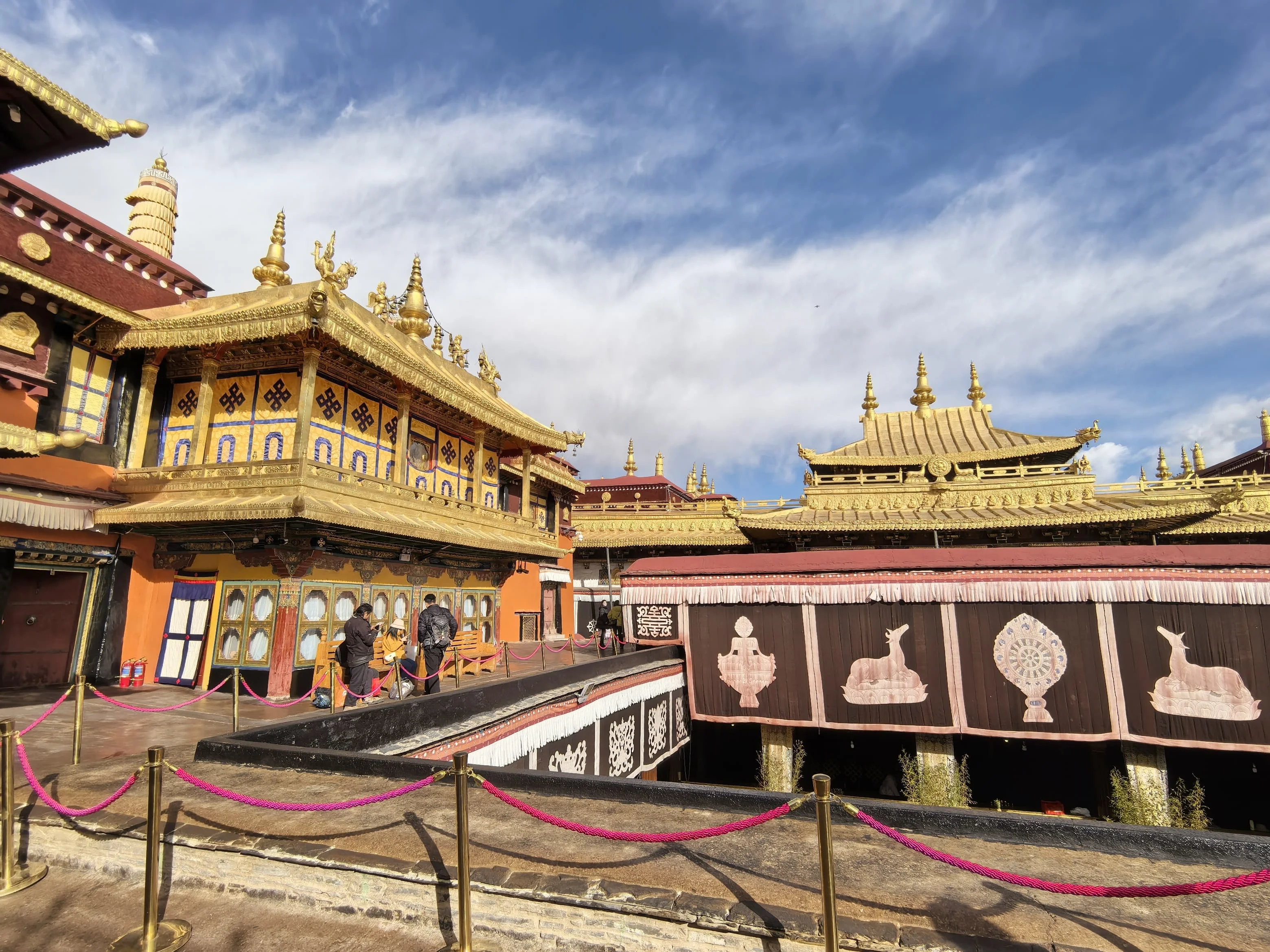 Tibetan monastery with golden roofs and colorful prayer flags