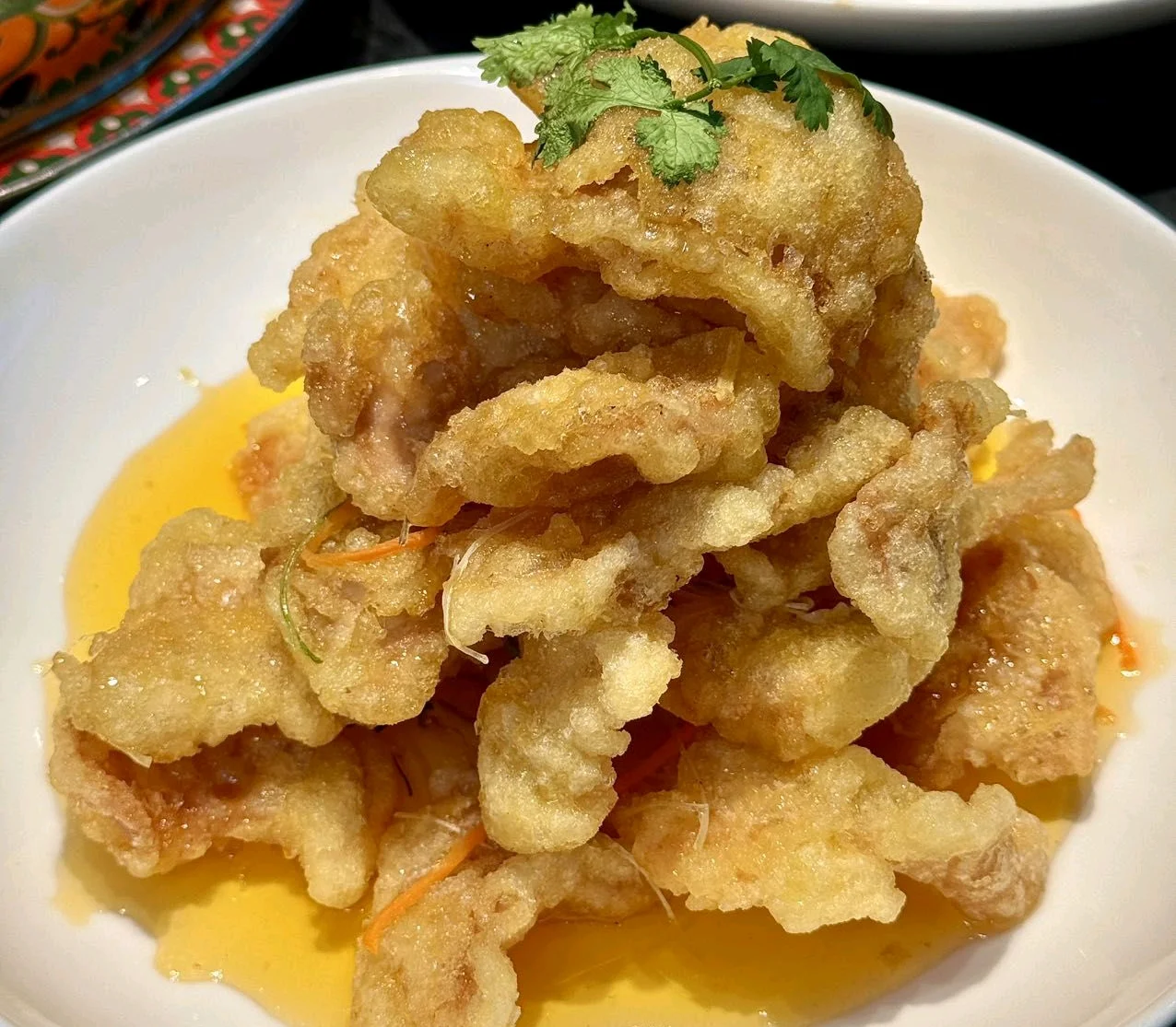 Northern Chinese dumplings on a plate with dipping sauce