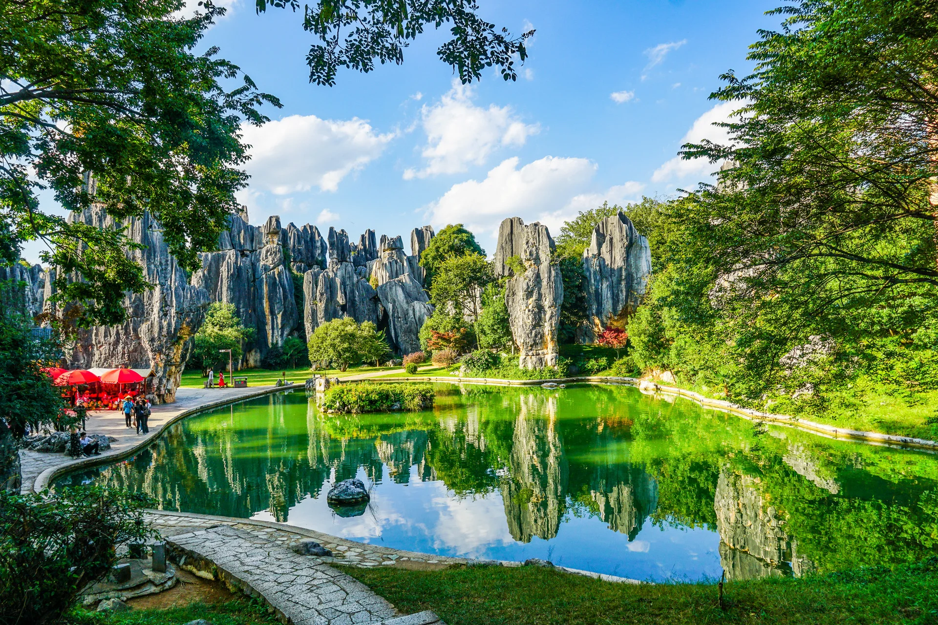 Panoramic Yunnan landscape with mountains, lake and ancient town