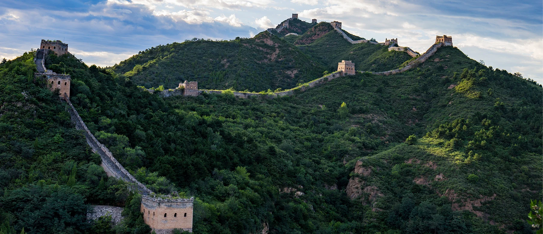 Hiking trail on a restored Great Wall section with mountain scenery