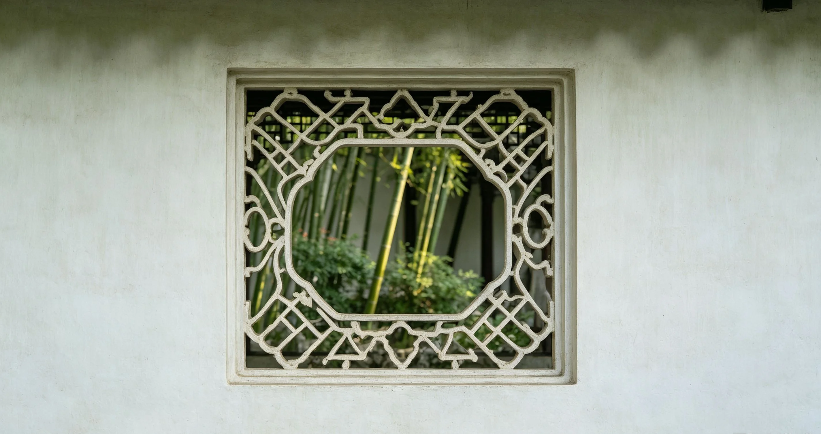 Covered walkway overlooking water and bonsai in a Suzhou classical garden
