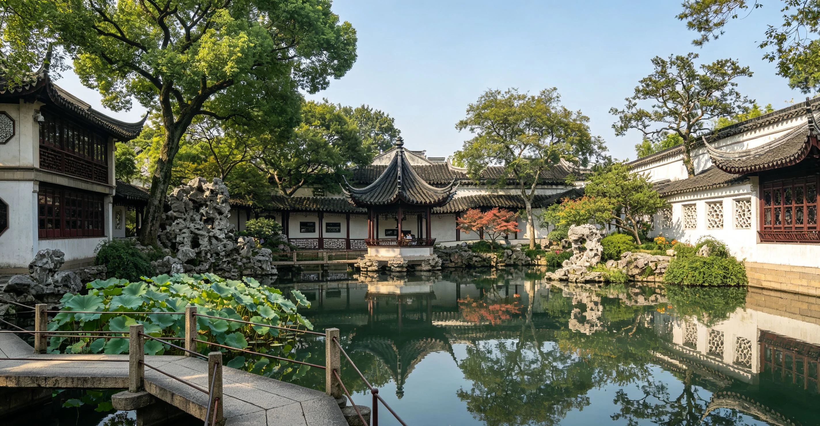 Seasonal flowers framing a pavilion and pond in Suzhou's classical garden