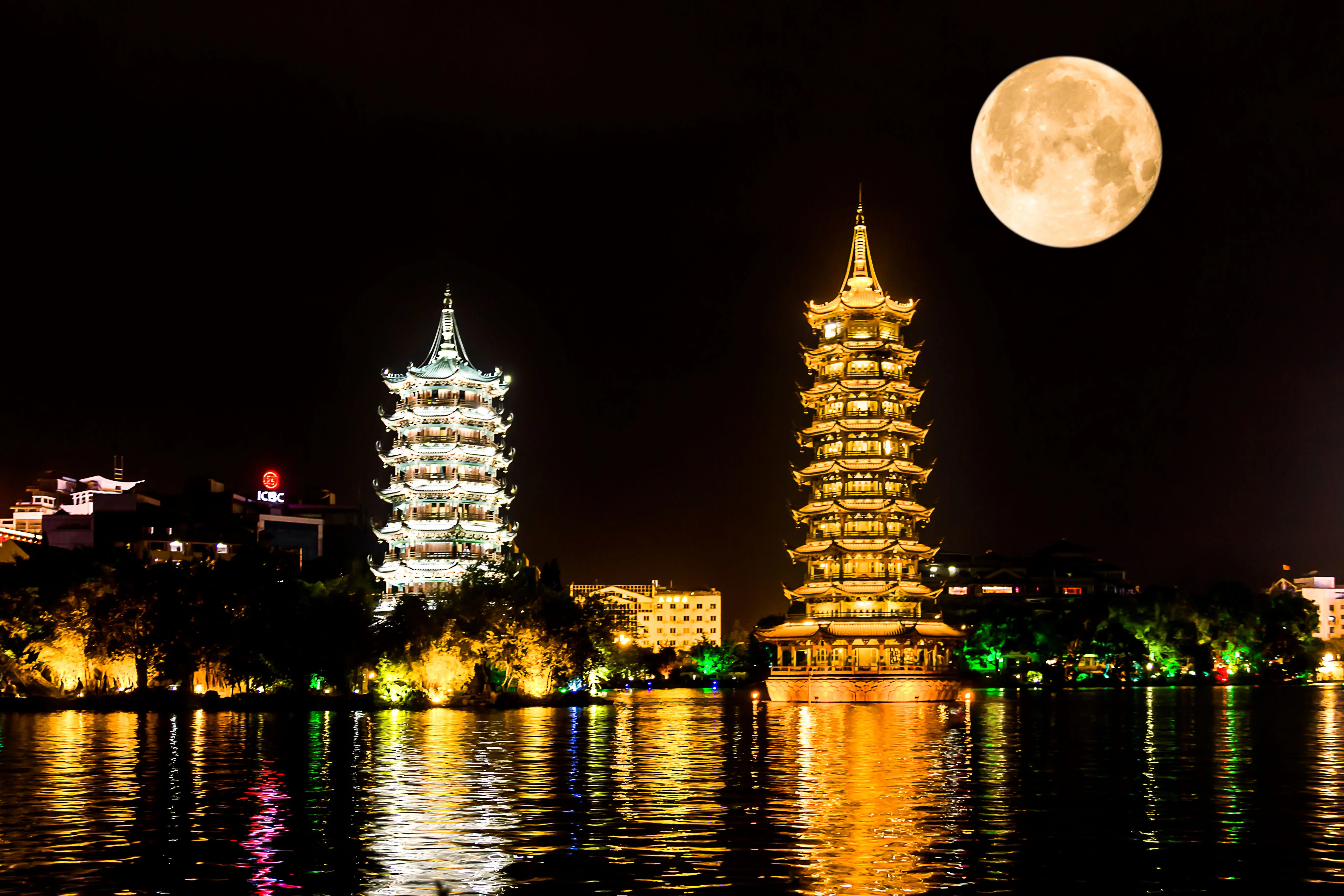 Guilin Two Rivers and Four Lakes cruise boat passing illuminated bridges at night
