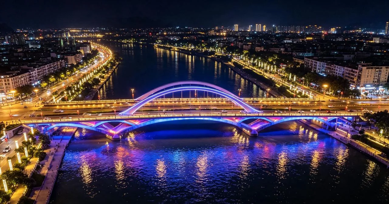 Night view of Guilin waterfront with cruise boats, glowing pagodas, and city reflections