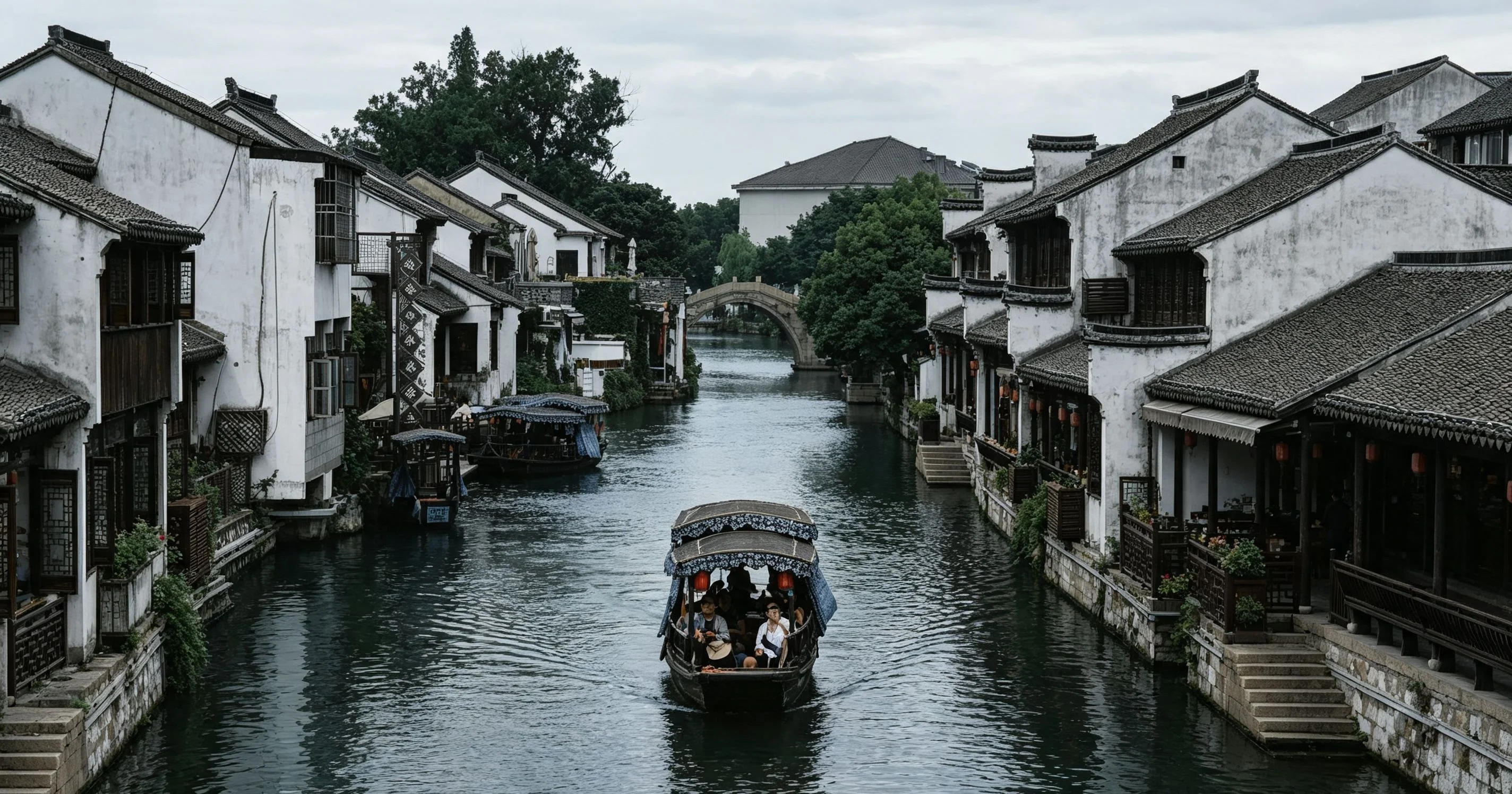 Twilight view of a Jiangnan water town with lanterns, canal reflections, and historic riverside architecture