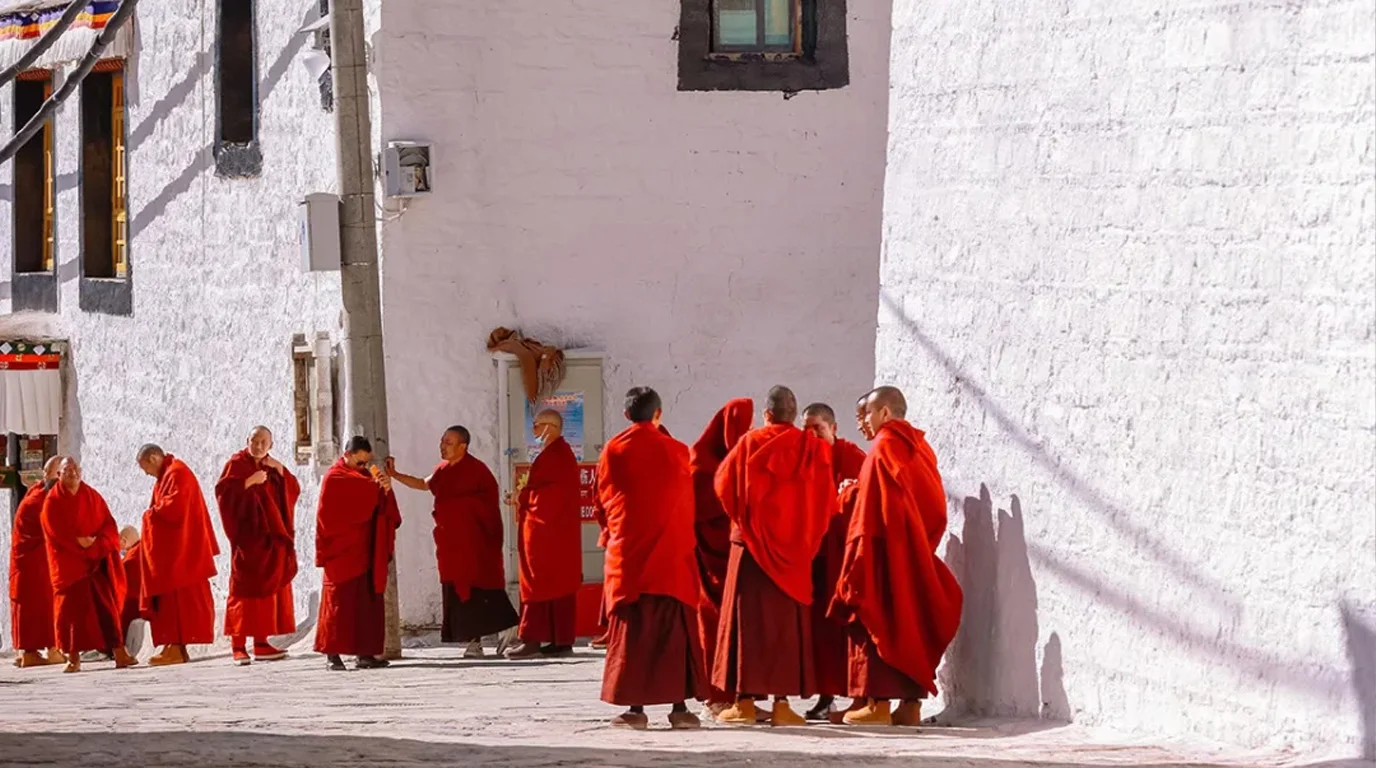 Sacred mountain monastery retreat in Tibet with white stupas and prayer wheels